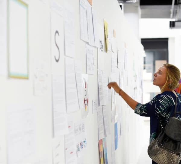 female team member checks brand strategy board